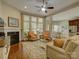 Comfortable living room with a fireplace, hardwood floors, and an open layout to the dining area at 1222 Kings Bottom Dr, Fort Mill, SC 29715