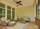 Comfortable screened-in patio with ceiling fan, wicker furniture, and large windows at 1222 Kings Bottom Dr, Fort Mill, SC 29715