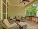 Relaxing screened porch with comfortable wicker furniture and views of lush greenery at 1222 Kings Bottom Dr, Fort Mill, SC 29715