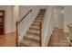 Carpeted staircase with wood railing at 1222 Kings Bottom Dr, Fort Mill, SC 29715