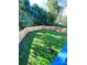 View from a blue-painted deck of a meticulously fenced, grassy backyard at 126 Pleasant Hill St, Lancaster, SC 29720