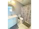 This bathroom offers a modern vanity, toilet, round mirror, and stylish shower curtain at 126 Pleasant Hill St, Lancaster, SC 29720