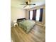 A comfortably sized bedroom featuring laminate flooring, natural lighting, and a modern ceiling fan at 126 Pleasant Hill St, Lancaster, SC 29720