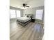 This bedroom boasts a ceiling fan, a large window with natural light, and beautiful laminate flooring at 126 Pleasant Hill St, Lancaster, SC 29720