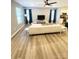 Bright living room with stylish wood-look floors, ceiling fan, and comfortable seating area at 126 Pleasant Hill St, Lancaster, SC 29720