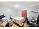 Simple bedroom with a white bed, red curtain, and desk area with lots of boxes at 1279 Rocky Creek Rd, Shelby, NC 28152