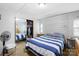 Cozy bedroom featuring a striped bedspread, closet, and wood-look accent wall at 1279 Rocky Creek Rd, Shelby, NC 28152