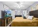 Spacious bedroom with a large bed, TV, ceiling fan, and decor signs at 1279 Rocky Creek Rd, Shelby, NC 28152