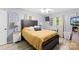Bedroom featuring a large bed, side tables with lamps, and bright window curtains at 1279 Rocky Creek Rd, Shelby, NC 28152