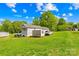 The exterior of the home features a well-maintained lawn and several storage units at 1279 Rocky Creek Rd, Shelby, NC 28152