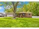 Charming brick home with a manicured lawn, mature shade tree, and an attached two-car garage at 1279 Rocky Creek Rd, Shelby, NC 28152