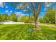 Spacious front yard featuring a large shade tree with hanging swing at 1279 Rocky Creek Rd, Shelby, NC 28152