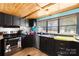 Kitchen features stainless steel appliances, black cabinets, and ample counter space at 1279 Rocky Creek Rd, Shelby, NC 28152