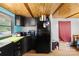 Kitchen featuring wood paneling, stainless steel appliances, and ample counter space at 1279 Rocky Creek Rd, Shelby, NC 28152