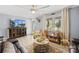 Well-lit living room with a large TV, decorative cabinet, comfortable armchair, and stylish furniture arrangement at 1279 Rocky Creek Rd, Shelby, NC 28152