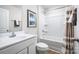 Bright white bathroom with a shower-tub combo, and white vanity at 129 Millstream Dr, China Grove, NC 28023