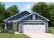 Charming single-story home with a two-car garage and a well-maintained front yard at 129 Millstream Dr, China Grove, NC 28023