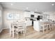 Bright kitchen with a dining nook and white cabinets, stainless steel appliances, and a spacious island with seating at 129 Millstream Dr, China Grove, NC 28023