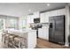 Modern kitchen featuring white cabinets, stainless steel appliances, and a spacious island with seating at 129 Millstream Dr, China Grove, NC 28023