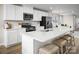 Bright kitchen features stainless appliances, white cabinets, stone countertop and an island with barstool seating at 129 Millstream Dr, China Grove, NC 28023