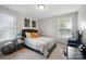Bedroom with a dark headboard bed, geometric wall art, and a bedside table at 13402 David Jennings Ave, Charlotte, NC 28213