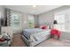 Bright bedroom with silver bedding, and red nightstand at 13402 David Jennings Ave, Charlotte, NC 28213