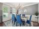 Elegant dining room with a crystal chandelier, large windows, and stylish decor at 13402 David Jennings Ave, Charlotte, NC 28213
