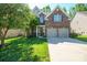 Charming two-story brick home featuring a well-manicured lawn and a two-car garage at 13402 David Jennings Ave, Charlotte, NC 28213