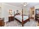 Comfortable bedroom with a four-poster bed, patterned rug, and ensuite bath access at 172 Harper Lee St, Davidson, NC 28036