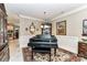 Formal dining area with a grand piano, decorative mirror, patterned rug, and detailed trim at 172 Harper Lee St, Davidson, NC 28036