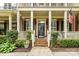 Inviting front porch with brick steps, white railings, and well-maintained landscaping at 172 Harper Lee St, Davidson, NC 28036
