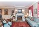 Elegant living room with fireplace, patterned furniture, decorative art, and refined accents at 172 Harper Lee St, Davidson, NC 28036