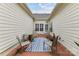 Private brick patio area with chairs and a table, ideal for outdoor seating and entertaining at 172 Harper Lee St, Davidson, NC 28036