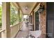 Inviting covered porch with rocking chairs, perfect for relaxing and enjoying the outdoors at 172 Harper Lee St, Davidson, NC 28036
