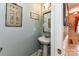 Charming powder room with pedestal sink and decorative accents at 172 Harper Lee St, Davidson, NC 28036