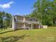 Rear exterior view of the two-story home, showcasing the backyard, lawn, and outdoor space at 1758 Bridlewood Ct, Gastonia, NC 28054