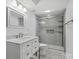 Bright bathroom featuring a modern vanity, marble tile, and a glass-enclosed shower at 1758 Bridlewood Ct, Gastonia, NC 28054