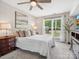 Cozy bedroom with a large window, ceiling fan, plush carpet, and neutral decor at 1758 Bridlewood Ct, Gastonia, NC 28054