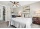 Comfortable bedroom featuring a ceiling fan, artwork, and a view of an office space at 1758 Bridlewood Ct, Gastonia, NC 28054