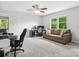 Spacious living room featuring large windows, comfortable seating, and ceiling fan at 1758 Bridlewood Ct, Gastonia, NC 28054