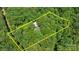 Expansive aerial view of a wooded lot, highlighted by estimated property lines at 208 Devonport Dr # 25, Weddington, NC 28104