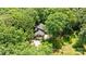 A high-angle shot reveals the property with its classic brick facade tucked away among dense trees at 208 Devonport Dr # 25, Weddington, NC 28104