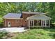 Brick home featuring a screened-in porch, patio, and expansive backyard at 208 Devonport Dr # 25, Weddington, NC 28104