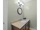 Simple bathroom with granite vanity, single sink, dark wood cabinets, and wood flooring at 208 Devonport Dr # 25, Weddington, NC 28104