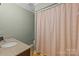 Functional bathroom featuring a shower with patterned curtain, granite vanity, and wood flooring at 208 Devonport Dr # 25, Weddington, NC 28104