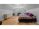 Cozy bedroom with hardwood floors, vaulted ceilings, skylight, and a bed with purple comforter at 208 Devonport Dr # 25, Weddington, NC 28104