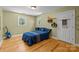Quaint bedroom with hardwood floors, two windows, and a blue comforter with a guitar in the corner at 208 Devonport Dr # 25, Weddington, NC 28104