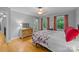 Bright bedroom featuring light gray walls, hardwood floors, a ceiling fan, and a large dresser and two windows at 208 Devonport Dr # 25, Weddington, NC 28104