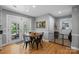 Bright breakfast nook features a round table, hardwood floors, and direct access to the backyard, ideal for casual dining at 208 Devonport Dr # 25, Weddington, NC 28104