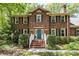 Charming brick home featuring a bright blue front door and manicured landscaping at 208 Devonport Dr # 25, Weddington, NC 28104